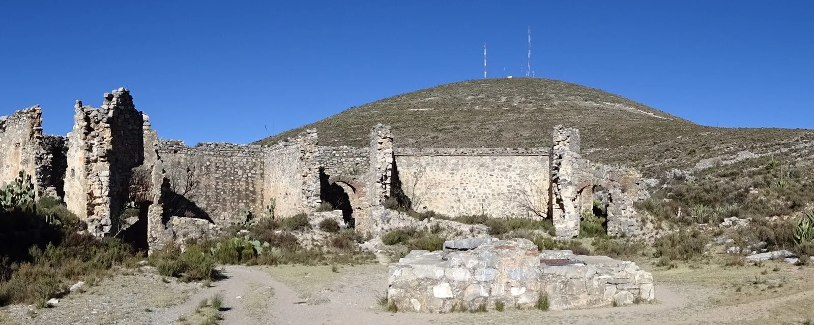 Las ruinas de una capilla en las afueras de Real de Catorce: muros de piedra sin techo al pie de un cerro pelado del altiplano potosino
